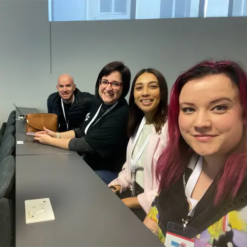 Frenette van der Walt speaker at the conference with learning and delivery team members.